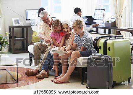 Grandparents With Grandchildren Arriving In Hotel Lobby View Large Photo Image Stock Photography - Grandparents With Grandchildren Arriving In Hotel Lobby. Fotosearch