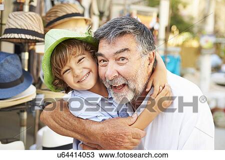 Grandson Trying On Hats With Grandfather At Store View Large Photo Image Stock Image - Grandson Trying On Hats With Grandfather At Store. Fotosearch