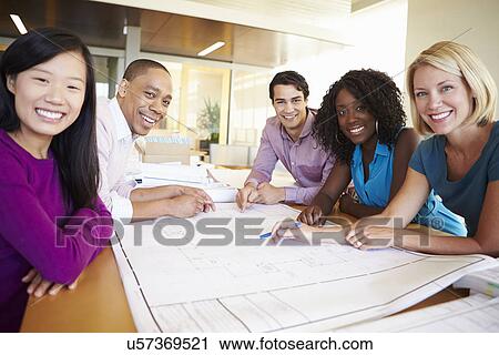 Group Of Architects Discussing Plans In Modern Office View Large Photo Image Stock Image - Group Of Architects Discussing Plans In Modern Office. Fotosearch