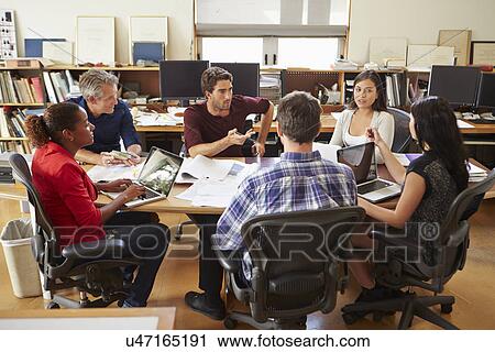 Group Of Architects Meeting Around Desk View Large Photo Image Stock Image - Group Of Architects Meeting Around Desk. Fotosearch