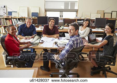 Group Of Architects Meeting Around Desk View Large Photo Image Stock Photo - Group Of Architects Meeting Around Desk. Fotosearch
