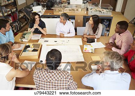 Group Of Architects Sitting Around Table Having Meeting View Large Photo Image Stock Image - Group Of Architects Sitting Around Table Having Meeting. Fotosearch