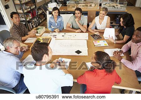 Group Of Architects Sitting Around Table Having Meeting View Large Photo Image Stock Image - Group Of Architects Sitting Around Table Having Meeting. Fotosearch