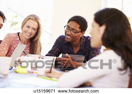 Group Of Business People Sitting Around Table In Meeting View Large Photo Image Stock Image - Group Of Business People Sitting Around Table In Meeting. Fotosearch