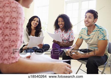 Picture - Group Of Business People Sitting On Chairs Having Meeting . Fotosearch