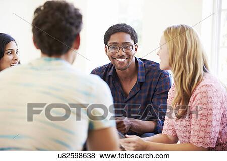 Group Of Business People Sitting On Chairs Having Meeting View Large Photo Image Stock Photo - Group Of Business People Sitting On Chairs Having Meeting . Fotosearch