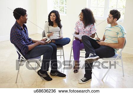 Stock Photograph - Group Of Business People Sitting On Chairs Having Meeting . Fotosearch