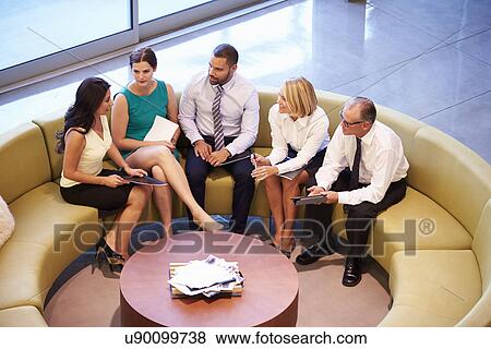 Group Of Businesspeople Having Meeting In Office Lobby View Large Photo Image Stock Photo - Group Of Businesspeople Having Meeting In Office Lobby. Fotosearch
