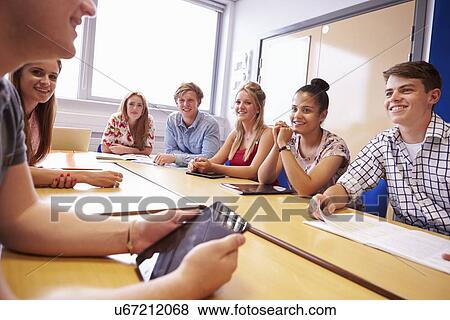 Stock Photo - Group Of College Students Sitting At Table Having Discussion. Fotosearch