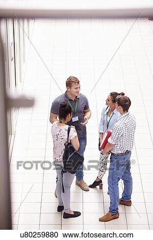Group Of College Students Standing In Hallway Talking View Large Photo Image Stock Image - Group Of College Students Standing In Hallway Talking. Fotosearch