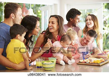 Group Of Families Enjoying Snacks At Home View Large Photo Image Stock Image - Group Of Families Enjoying Snacks At Home. Fotosearch