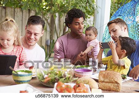 Group Of Fathers With Children Enjoying Outdoor Meal At Home View Large Photo Image Stock Photo - Group Of Fathers With Children Enjoying Outdoor Meal At Home. Fotosearch