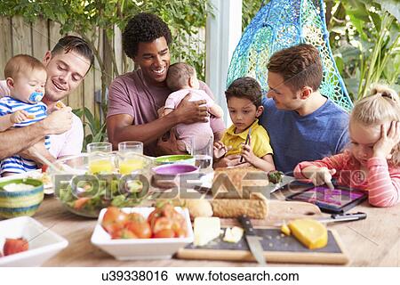 Group Of Fathers With Children Enjoying Outdoor Meal At Home View Large Photo Image Stock Photograph - Group Of Fathers With Children Enjoying Outdoor Meal At Home. Fotosearch