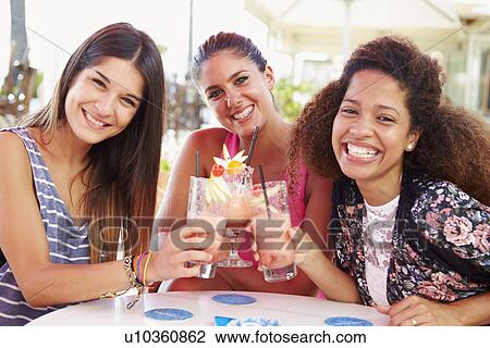 Group Of Female Friends Drinking Cocktails At Outdoor Bar View Large Photo Image Stock Image - Group Of Female Friends Drinking Cocktails At Outdoor Bar. Fotosearch
