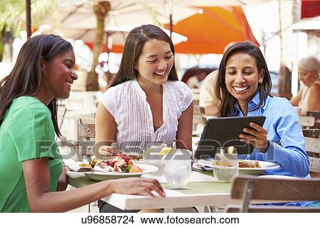 Group Of Female Friends Enjoying Lunch In Outdoor Restaurant View Large Photo Image Picture - Group Of Female Friends Enjoying Lunch In Outdoor Restaurant. Fotosearch
