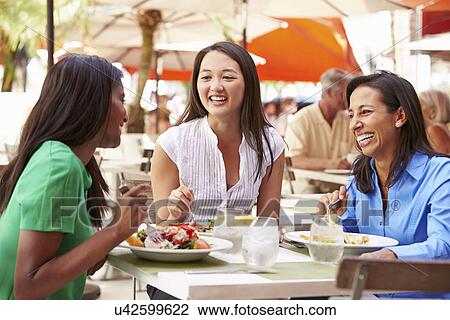 Group Of Female Friends Enjoying Lunch In Outdoor Restaurant View Large Photo Image Stock Image - Group Of Female Friends Enjoying Lunch In Outdoor Restaurant. Fotosearch