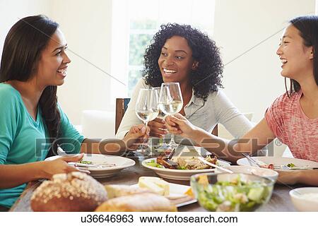 Group Of Female Friends Enjoying Meal At Home View Large Photo Image Stock Image - Group Of Female Friends Enjoying Meal At Home. Fotosearch