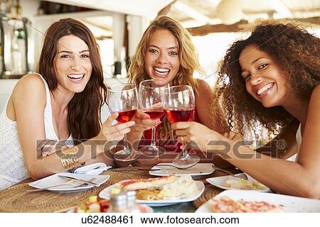 Group Of Female Friends Enjoying Meal In Outdoor Restaurant View Large Photo Image Stock Image - Group Of Female Friends Enjoying Meal In Outdoor Restaurant. Fotosearch