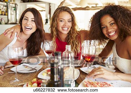 Group Of Female Friends Enjoying Meal In Outdoor Restaurant View Large Photo Image Stock Image - Group Of Female Friends Enjoying Meal In Outdoor Restaurant. Fotosearch