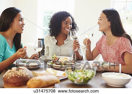 Group Of Female Friends Enjoying Meal At Home View Large Photo Image Stock Photo - Group Of Female Friends Enjoying Meal At Home. Fotosearch