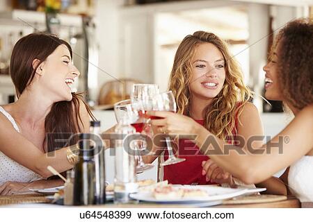 Group Of Female Friends Enjoying Meal In Outdoor Restaurant View Large Photo Image Stock Photo - Group Of Female Friends Enjoying Meal In Outdoor Restaurant. Fotosearch