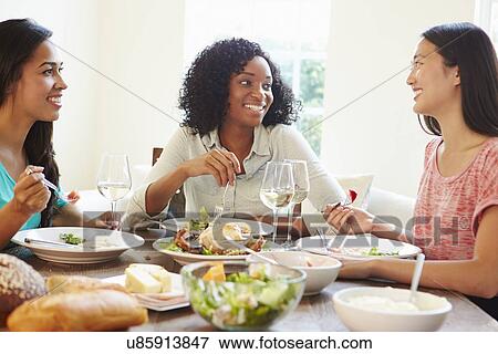 Group Of Female Friends Enjoying Meal At Home View Large Photo Image Stock Photo - Group Of Female Friends Enjoying Meal At Home. Fotosearch