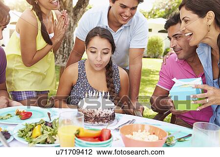 Stock Image - Group Of Friends Celebrating Birthday At Home. Fotosearch