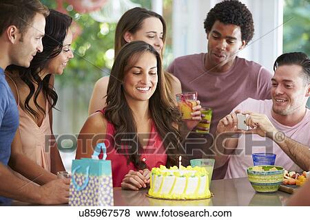Stock Photo - Group Of Friends Celebrating Birthday At Home. Fotosearch
