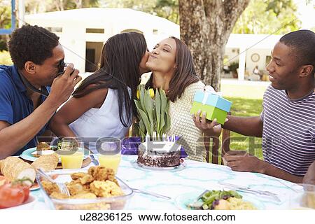 Stock Photography - Group Of Friends Celebrating Birthday At Home. Fotosearch