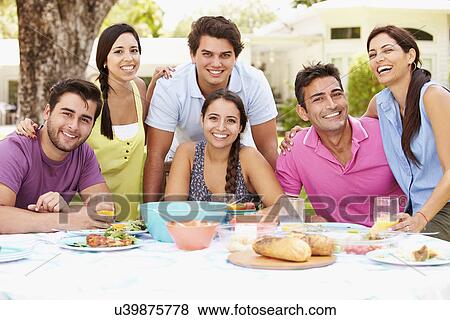 Group Of Friends Celebrating Enjoying Meal In Garden At Home View Large Photo Image Stock Photo - Group Of Friends Celebrating Enjoying Meal In Garden At Home. Fotosearch
