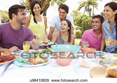 Group Of Friends Celebrating Enjoying Meal In Garden At Home View Large Photo Image Stock Photography - Group Of Friends Celebrating Enjoying Meal In Garden At Home. Fotosearch
