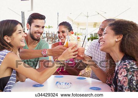 Group Of Friends Drinking Cocktails At Outdoor Bar View Large Photo Image Picture - Group Of Friends Drinking Cocktails At Outdoor Bar. Fotosearch