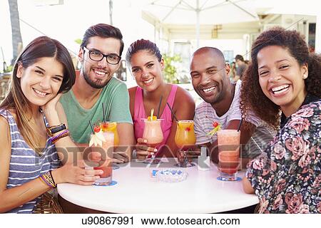 Group Of Friends Drinking Cocktails At Outdoor Bar View Large Photo Image Stock Image - Group Of Friends Drinking Cocktails At Outdoor Bar. Fotosearch