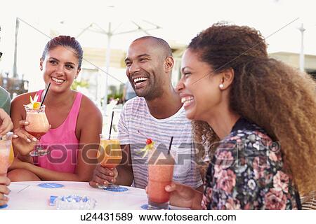 Group Of Friends Drinking Cocktails At Outdoor Bar View Large Photo Image Stock Photo - Group Of Friends Drinking Cocktails At Outdoor Bar. Fotosearch