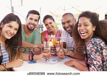 Group Of Friends Drinking Cocktails At Outdoor Bar View Large Photo Image Stock Photo - Group Of Friends Drinking Cocktails At Outdoor Bar. Fotosearch
