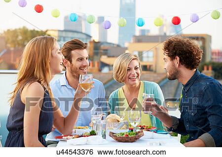 Group Of Friends Eating Meal On Rooftop Terrace View Large Photo Image Stock Photograph - Group Of Friends Eating Meal On Rooftop Terrace. Fotosearch