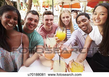 Group Of Friends Enjoying Drinks In Outdoor Restaurant View Large Photo Image Stock Image - Group Of Friends Enjoying Drinks In Outdoor Restaurant. Fotosearch