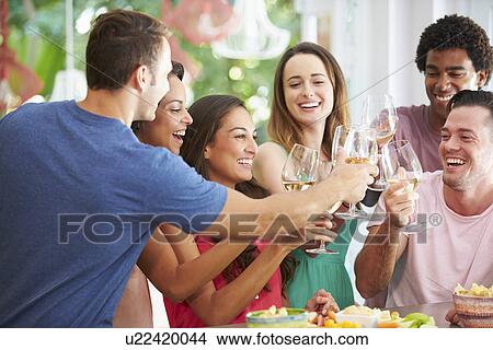 Group Of Friends Enjoying Drinks Party At Home View Large Photo Image Picture - Group Of Friends Enjoying Drinks Party At Home. Fotosearch