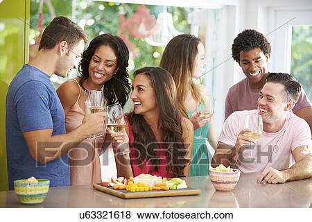 Stock Photo - Group Of Friends Enjoying Drinks Party At Home. Fotosearch