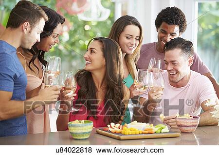 Stock Photo - Group Of Friends Enjoying Drinks Party At Home. Fotosearch