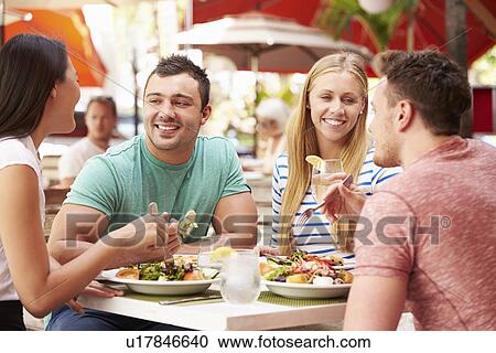 Group Of Friends Enjoying Lunch In Outdoor Restaurant View Large Photo Image Stock Image - Group Of Friends Enjoying Lunch In Outdoor Restaurant. Fotosearch