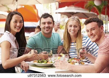 Group Of Friends Enjoying Lunch In Outdoor Restaurant View Large Photo Image Stock Image - Group Of Friends Enjoying Lunch In Outdoor Restaurant. Fotosearch