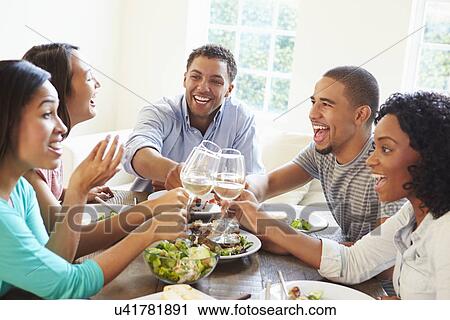 Group Of Friends Enjoying Meal At Home Together View Large Photo Image Stock Image - Group Of Friends Enjoying Meal At Home Together. Fotosearch