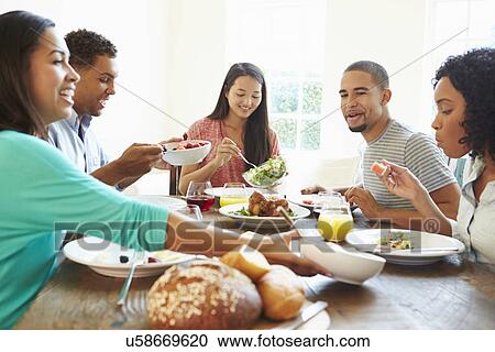 Group Of Friends Enjoying Meal At Home Together View Large Photo Image Stock Image - Group Of Friends Enjoying Meal At Home Together. Fotosearch