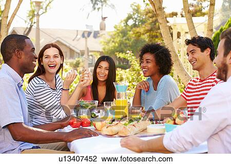 Group Of Friends Enjoying Meal At Outdoor Party In Back Yard View Large Photo Image Stock Image - Group Of Friends Enjoying Meal At Outdoor Party In Back Yard. Fotosearch