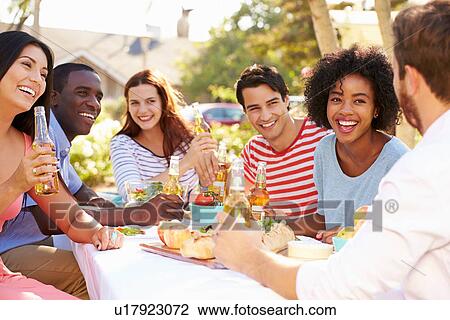 Group Of Friends Enjoying Meal At Outdoor Party In Back Yard View Large Photo Image Stock Image - Group Of Friends Enjoying Meal At Outdoor Party In Back Yard. Fotosearch