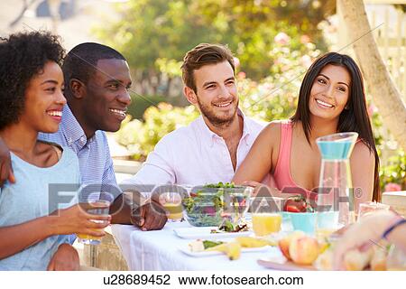 Group Of Friends Enjoying Meal At Outdoor Party In Back Yard View Large Photo Image Stock Image - Group Of Friends Enjoying Meal At Outdoor Party In Back Yard. Fotosearch