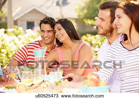 Group Of Friends Enjoying Meal At Outdoor Party In Back Yard View Large Photo Image Stock Image - Group Of Friends Enjoying Meal At Outdoor Party In Back Yard. Fotosearch