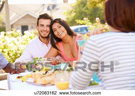 Group Of Friends Enjoying Meal At Outdoor Party In Back Yard View Large Photo Image Stock Image - Group Of Friends Enjoying Meal At Outdoor Party In Back Yard. Fotosearch