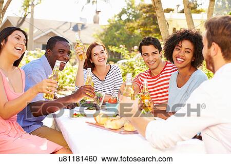 Group Of Friends Enjoying Meal At Outdoor Party In Back Yard View Large Photo Image Stock Image - Group Of Friends Enjoying Meal At Outdoor Party In Back Yard. Fotosearch